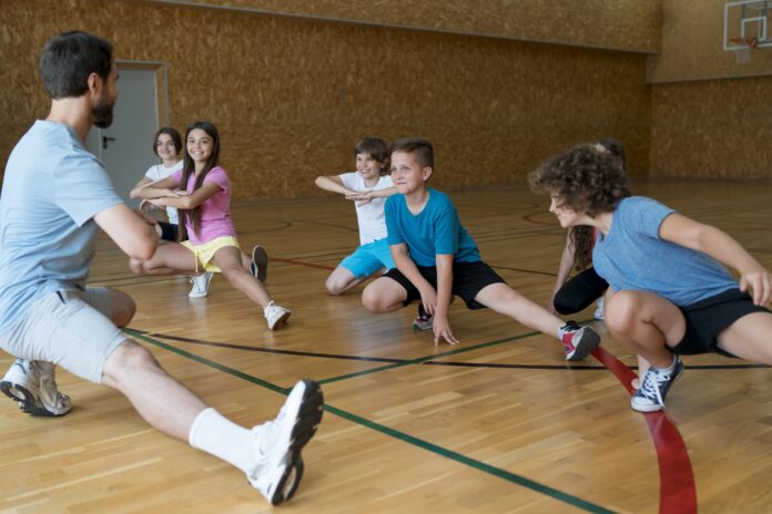 medium-shot-kids-exercising-school-gym